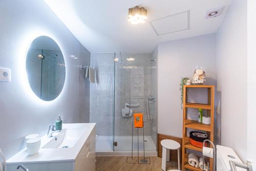a bathroom with a shower and a sink and a mirror at Marina Tower Center in Ponta Delgada