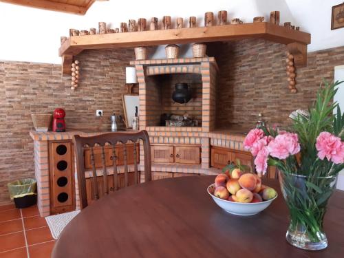 a kitchen with a table with a bowl of fruit at Quinta do Vale Encantado "the Valley" - Santarém - Portugal in Calhariz