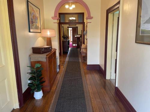 a hallway with an archway and a hallway with a hallway at Hanlon Guest House in Stanley