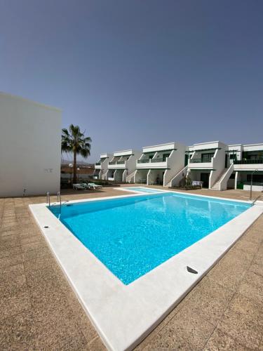 a swimming pool in front of a building at Casa Luna in Puerto del Carmen