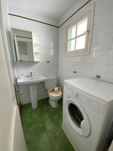 a bathroom with a washing machine and a sink at Casa Luna in Puerto del Carmen