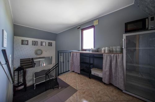 a kitchen with blue walls and a sink and a table at Pensjonat Basia in Dziwnówek