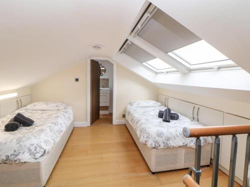 two beds in a attic bedroom with a skylight at 3 Pheasant Lane in Deepcar