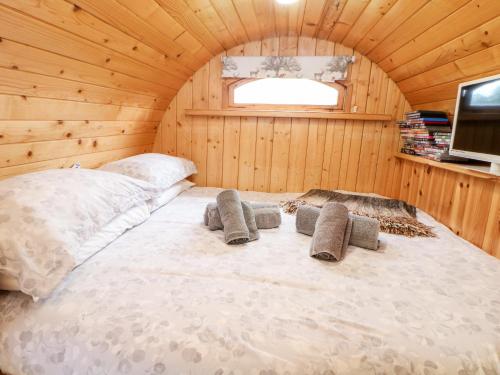 a bedroom with a bed in a wooden room at 3 Pheasant Lane in Deepcar