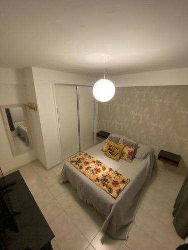 a bedroom with a bed and a light at Excelente depto sobre Bv Galvez in Santa Fe