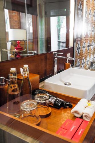 a bathroom with a counter with a sink and a mirror at Sampatti Villas in Seminyak