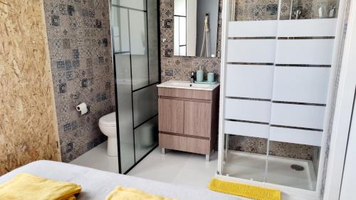 a bathroom with a shower and a sink and a toilet at Family Surf Home - Hostel in Mafra