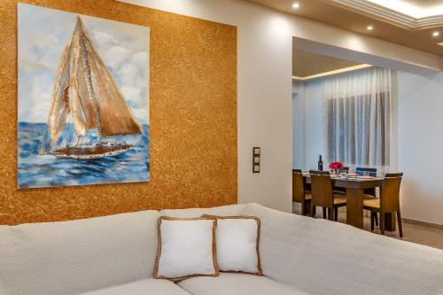 1 dormitorio con una gran pintura de un velero en la pared en Villa Alexandra, en Kolimvárion
