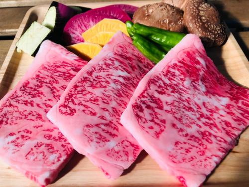 four different types of food on a cutting board at 森の宿り 那須別邸まるやま in Nasu