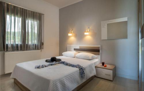 a bedroom with a bed with a hat on it at Exochiko Kalamitsi in Kalamitsi