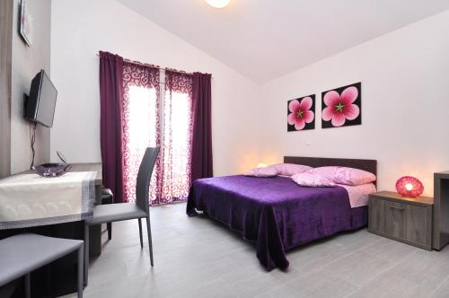 En eller flere senger på et rom på Apartments Zizic