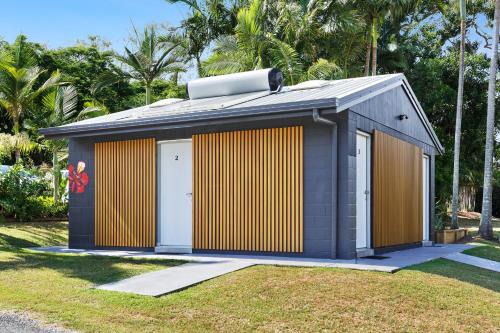 a smallshed with a yellow and orange facade at Poinciana at Cooee Bay in Yeppoon
