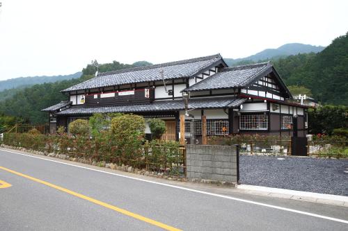 a black and white building on the side of a road at 古民家ー東秩父村 in Ogawa