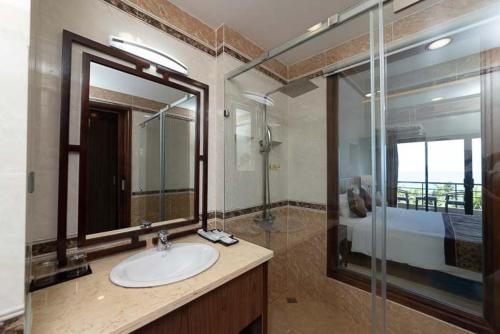 a bathroom with a sink and a glass shower at Con Dao Resort in Con Dao