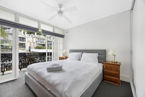 a bedroom with a bed and a large window at WIND85P - Pet Friendly Paddo Terrace in Sydney