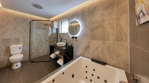 een badkamer met een bad en een toilet bij The Palms Dubbo in Dubbo