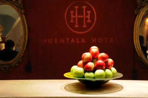 a bowl of apples on a plate on a table at Huentala Hotel in Mendoza