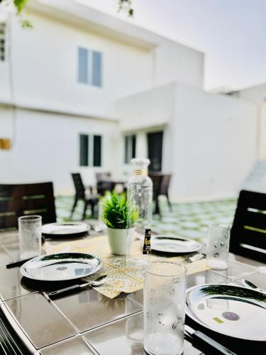 a table with plates and glasses on top of it at Hostel ivory in Jaipur