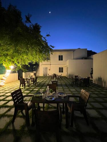 a patio with a table and chairs at night at Hostel ivory in Jaipur