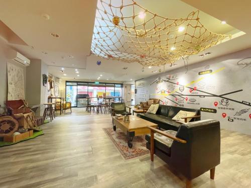 a living room with a piano and a restaurant at Roaders Hotel Hualien Dongda in Hualien City