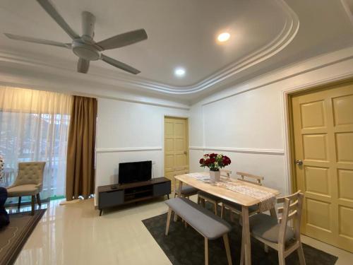 a living room with a table and chairs and a ceiling at Teratak Nenda in Ampang