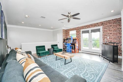 a living room with a couch and a fireplace at La Casa Blanca-Rooftop Skyline with Gameroom in Houston