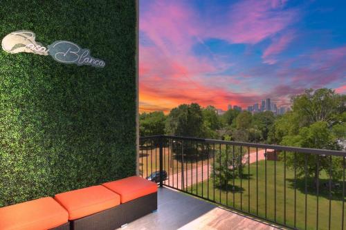 a balcony with a bench and a view of the city at La Casa Blanca-Rooftop Skyline with Gameroom in Houston