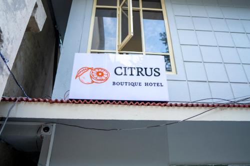 a sign on the side of a building with a window at Citrus Boutique Hotel in Gangtok