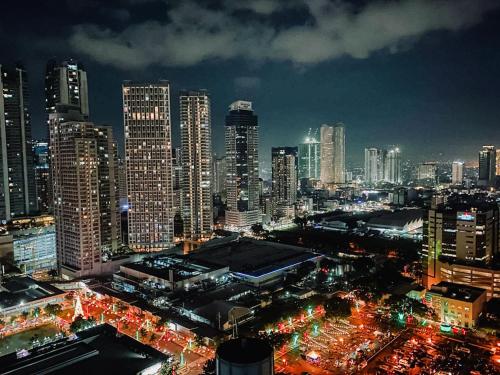 a city skyline at night with lit up buildings at Fame Residences Tower-1 Unit 3207 in Mandaluyong 1 Br w Balcony City view in Manila