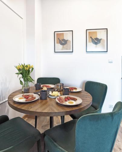 a dining room table with plates of food on it at Willa La Calma in Łeba