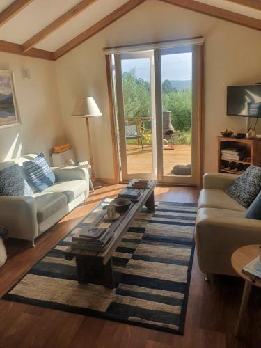 a living room with a couch and a coffee table at Wanderers Cottage in Woodbridge