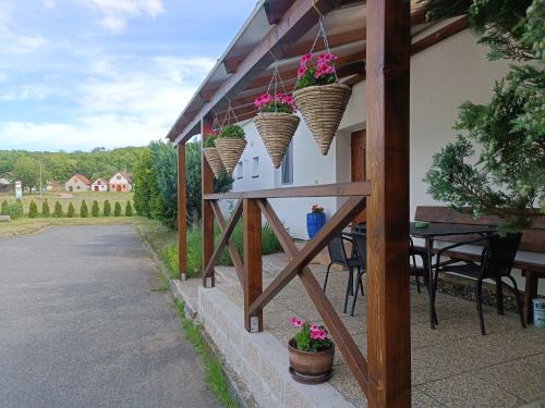 a patio with flower baskets on the side of a building at Penzion Kelčany u Kyjova in Kelčany