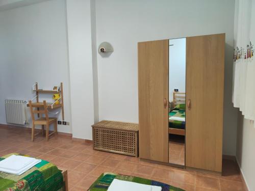 a room with a mirror and a bedroom with a bed at Beteyà Hostel Don Bosco in Catania
