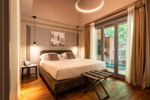 a bedroom with a bed and a large window at Loly Boutique Hotel Roma in Rome