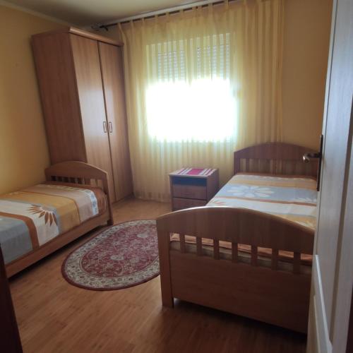 a small bedroom with two beds and a window at Apartman Becici beach in Bečići
