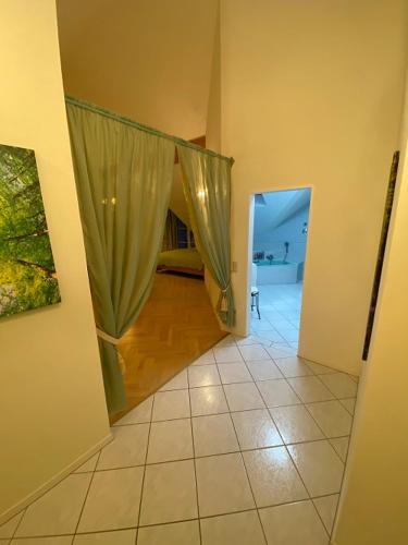 a hallway with a room with a bed and a curtain at Ferienwohnung Lichtgalerie in Traunstein