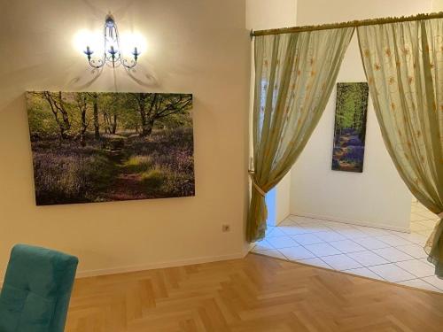 a living room with a couch and a painting on the wall at Ferienwohnung Lichtgalerie in Traunstein