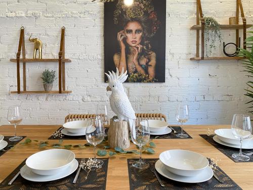 a dining room table with a table set with plates and glasses at Amplio y moderno apartamento con tarima refrescante by Staynnapartments in Bilbao
