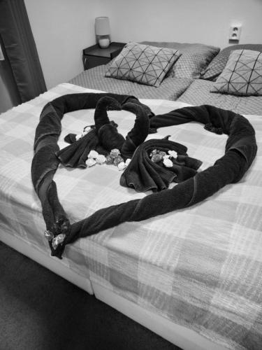 a baby laying on a bed with a blanket at B&B Royal Liberty in Ústí nad Labem