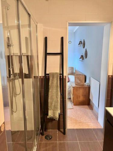 a bathroom with a shower with a towel on the wall at Andorinha Levante in Grândola