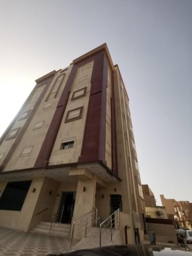 a tall building with stairs in front of it at فندق منازل قباء الفندقية in Al Madinah