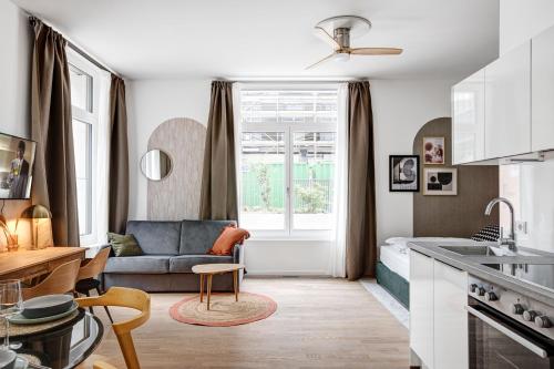 a small kitchen and living room with a couch at Arbio I Luxury Apartments in East Side Gallery in Berlin