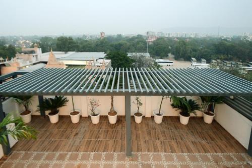 a balcony with potted plants on a roof at Hotel Life Inn in Jaipur