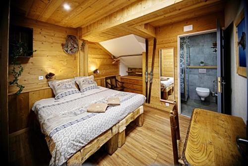 A bed or beds in a room at CHALET HOTEL La TUVIERE BIKE INN