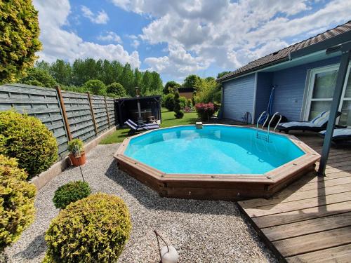 a swimming pool in the backyard of a house at Gîte et chambre d'hôtes en Champagne in Courtisols