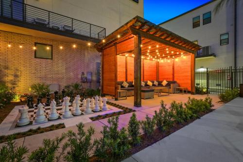 a backyard with a large chess board in a yard at Bienville Villas: Brand New 4BR in New Orleans