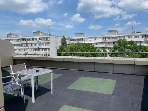 a balcony with a table and chairs on a building at Samaa Hotel in Bucharest