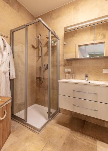 a bathroom with a shower and a sink at Pannonia Appartements in Neusiedl am See