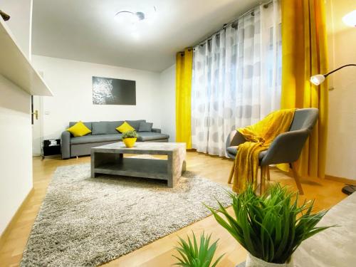 a living room with a couch and a table at Centre ville au calme , Parking privé intérieur CAR et BIKE in Saverne