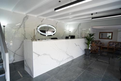 a lobby with a marble counter and a mirror at Parthenis Riviera Hotel in Athens